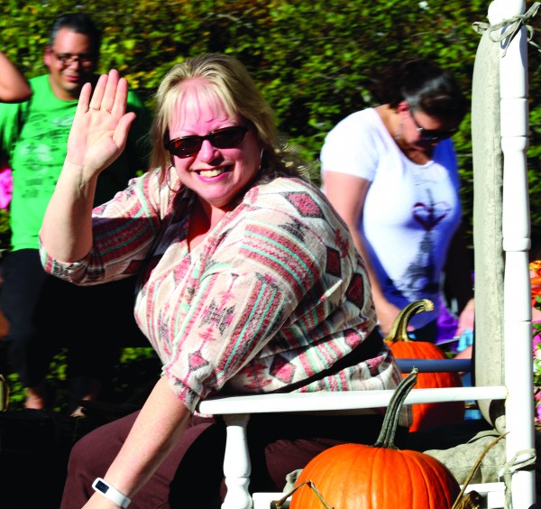Kim S. Lambert waves from the VOC float which took first place in the Tribal/Business Division at the 2015 Cherokee Indian Fair Parade on Tuesday, Oct. 6. (SC0TT MCKIE B.P./One Feather) 