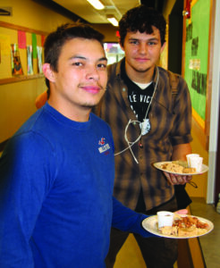 Cherokee High School seniors Kenny Griffin and Daniel Griffin were among over 400 students, faculty and community members who received Indian dinners at the school on Thursday, Nov. 19.  (SCOTT MCKIE B.P./One Feather)