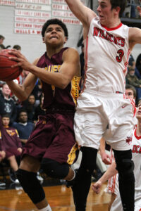 Cherokee's Justus Day (#3) goes for a shot around Andrews' Tyler Rose (#3).  