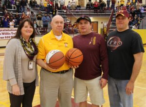Willis Tullos (2nd from left), Braves head coach, was honored during halftime of the girls varsity game in recognition of his 600th career win which he got earlier this season.  Shown (left-right) are – Debora Foerst, Cherokee High School principal; Tullos; Peanut Crowe, CHS athletic director; and Dick Crowe, Cherokee School Board.  