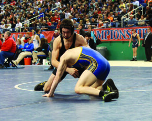 Toineeta (top) works hard against Daughtry in the final match. 