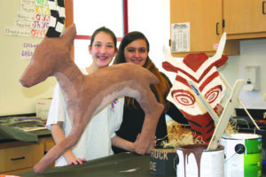 Makayla Trantham and Maiya Davis are shown with a few of the props they have been working on for the Musical Theater Department’s upcoming production of the Lion King Jr.  (Photo contributed) 
