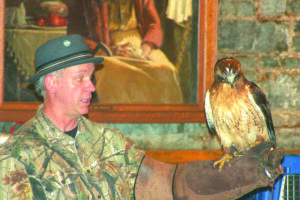 Michael Skinner, executive director of the Balsam Mountain Trust, shows a female red-tailed hawk named Cheyenne at a previous year’s Birds of Prey presentation at the Oconaluftee Multipurpose Room. (SCOTT MCKIE B.P./One Feather) 
