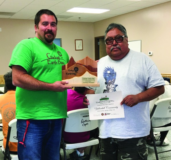 Chumper Walker (left) presents two Gadugi Earth Day Awards to Reuben Teeesatuskie of the Yellowhill Community.  Teesatuskie is shown receiving an individual award for most recycling in his community as well as the Community Club Award, created by William Radford, on behalf of the Yellowhill Community Club who won with a total of 764 pounds of recyclable and shredded materials.   (Photo by Tammy Jackson/EBCI Cooperative Extension) 
