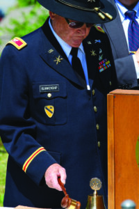  Col. Bob Blankenship (Ret.), U.S. Army, rings a bell as names of EBCI tribal members killed in action is read. 