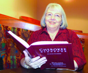 Joyce Cooper, recently retired from the Museum of the Cherokee Indian, holds a copy of the revised Cherokee Hymnbook, a project she was proud to have worked on.  (ROBERT JUMPER/One Feather) 