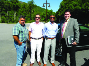 Mickey Duvall (right), EBCI Secretary of Commerce, and Glenn Bradley (left), EBCI director of road maintenance and tribal construction, showed Mike McGhee (2nd from right), Walmart senior director of real estate from Charlotte, and Ernie Ravenel, ECDC Realty from Summerville, SC around Cherokee on Thursday, June 16. (ROBERT JUMPER/One Feather) 