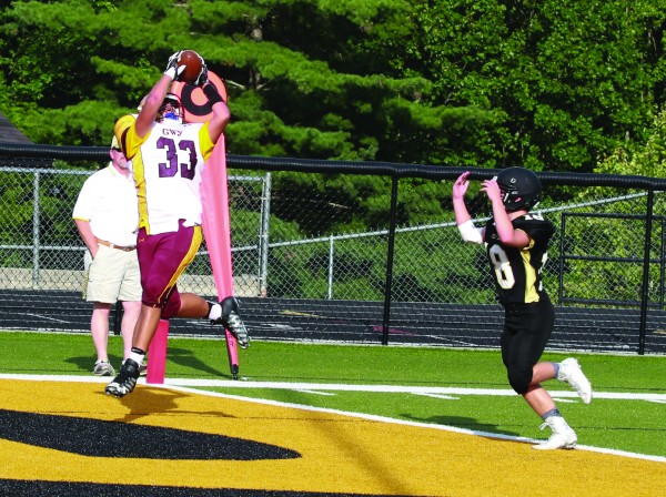 Even Hayesville’s Meade Gibson (#18) seems to signal a touchdown as Cherokee’s Sterling Santa-Maria (#33) makes a 33-yard grab in the first quarter. 