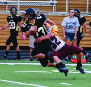 Cherokee’s Ayden Evans (#32), who led the Braves with nine, makes a solid tackle on Hayesville’s Blake McClure (#23). 