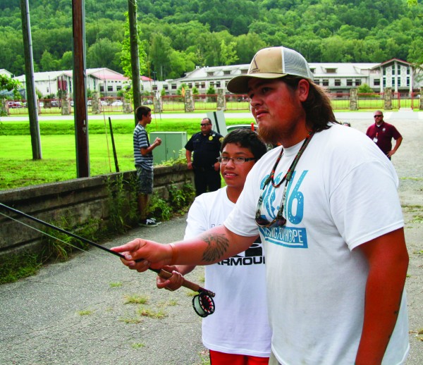 Michael Bradley (right) helps Richard Mata with his casting technique during a CMS Wilderness class fly fishing demonstration on Thursday, Aug. 18.  (SCOTT MCKIE B.P./One Feather photos) 
