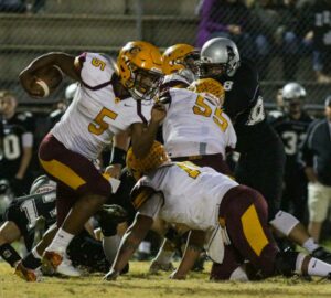  SEALED: Cherokee’s linemen, including Will Davis (#55) seal the inside to spring Isaiah Evans (#5) on a run in the second half. On the night, Evans 19 times for 77 yards and two touchdowns. 