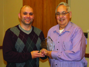 Skooter McCoy (left), Cherokee Boys Club general manager, presents the Frell Owl Award to Wilbur Paul.  